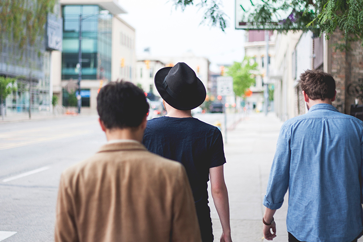 Three men walking in the city