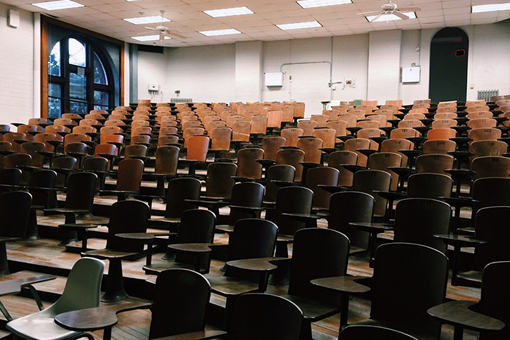 An empty classroom full of chairs