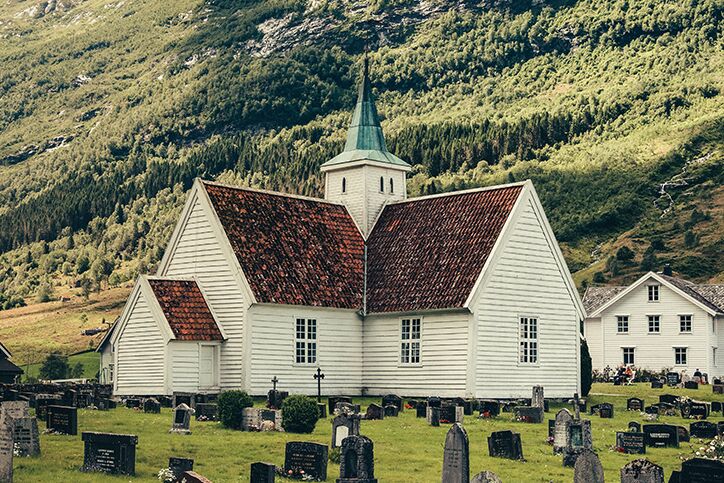 A church in the hills surrounded by a graveyard