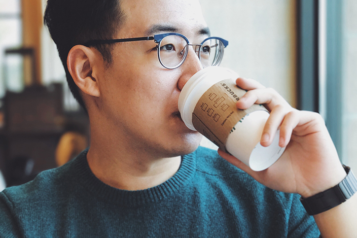 A man drinking a cup of coffee