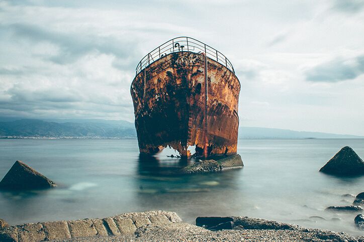 A rusty shipwreck on the coast