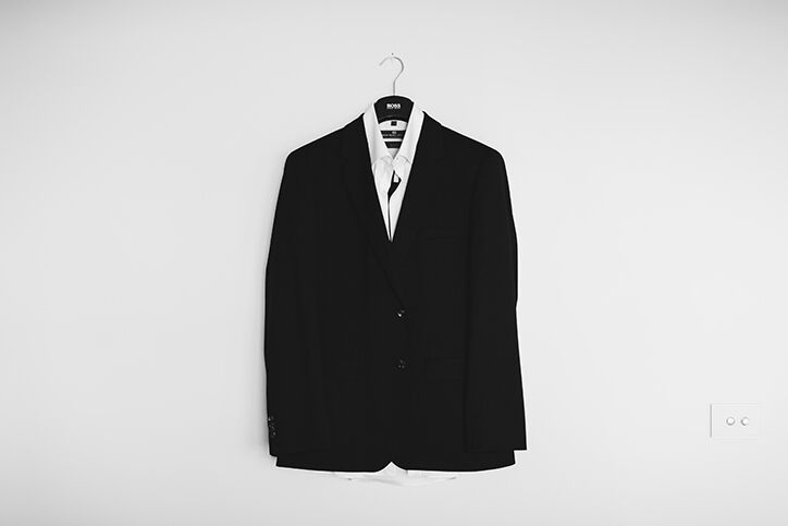 A suit hanging against a wall