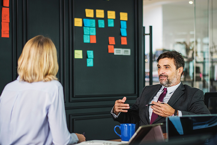 A man and woman in a meeting