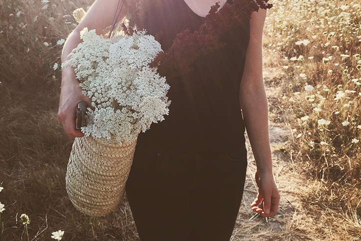 A woman carrying a basket of flowers
