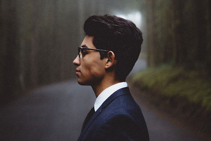 The profile of a young man in a suit