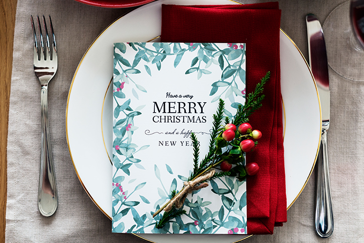 A table setting with a card that says Merry Christmas