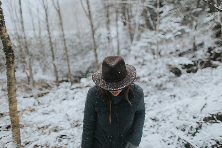 A woman in a hat walking in the snow