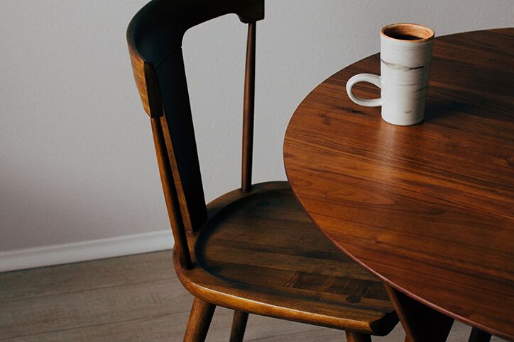 A coffee mug sitting on an empty table