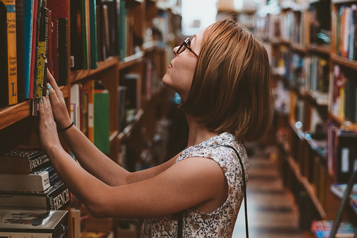 A woman looking at books in a library
