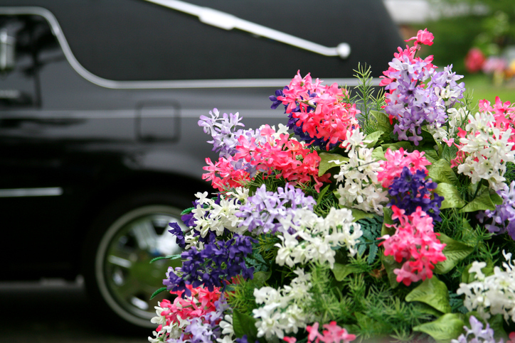 hearse next to floral arrangement