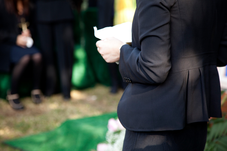 A woman in a suit reading a eulogy