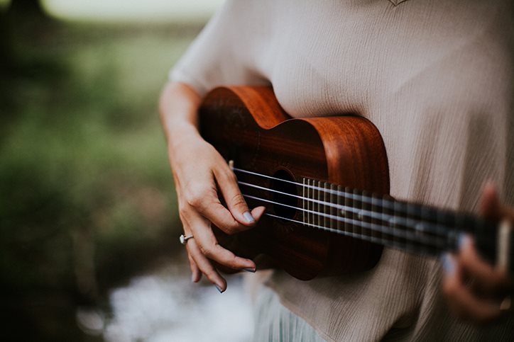 A woman playing the ukulele