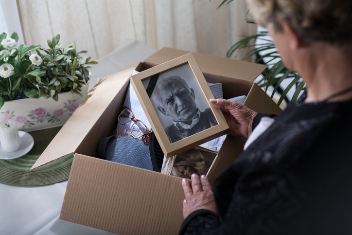 woman looking at framed photo