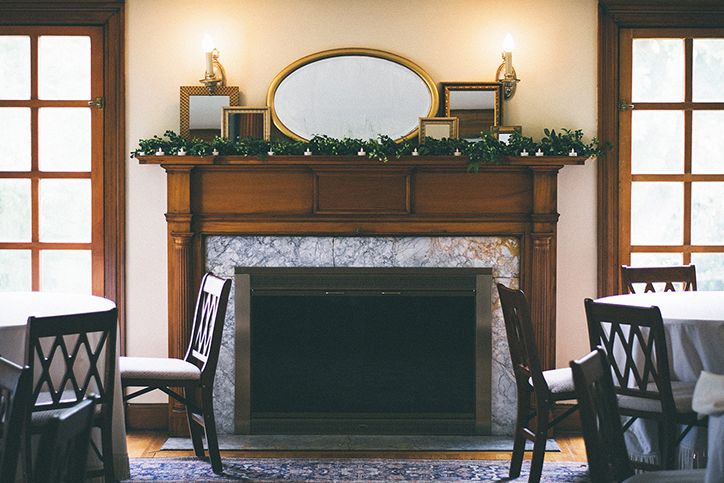 A photo of a funeral directors parlor, with chairs and a fireplace