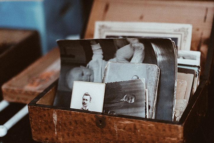 A box of old family photos sitting in a storage box.