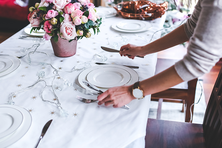 A woman setting the table for a funeral home's event
