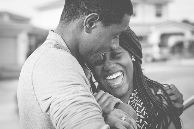 A black and white picture of a couple laughing