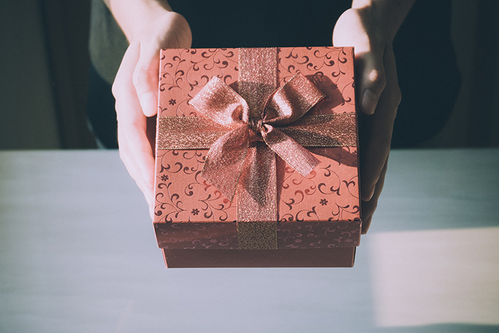 A gift wrapped in red paper and a bow