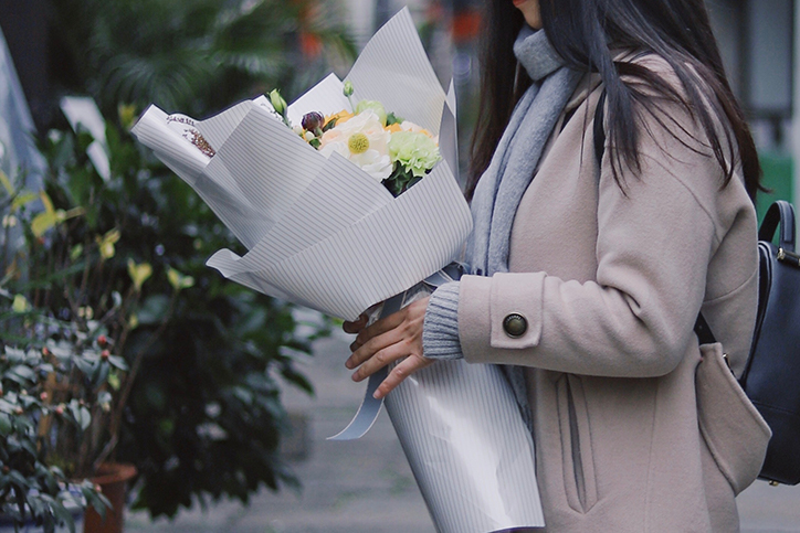 woman holding bouquet of flowers