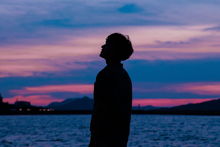 A man's silhouette in front of a sunset