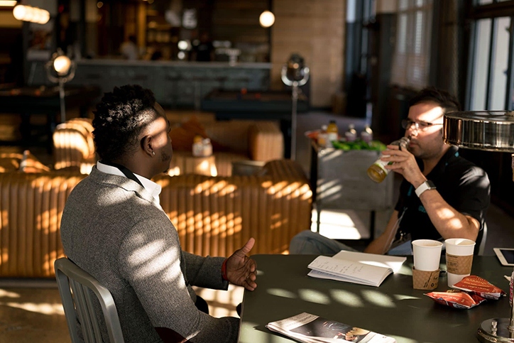 Two men in a cafe talking