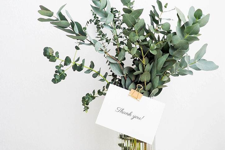 vase of greenery with a thank-you note