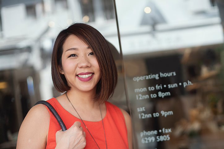 woman smiling outside of business
