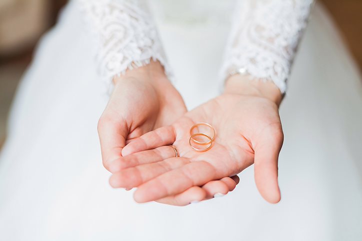Bride holding wedding rings