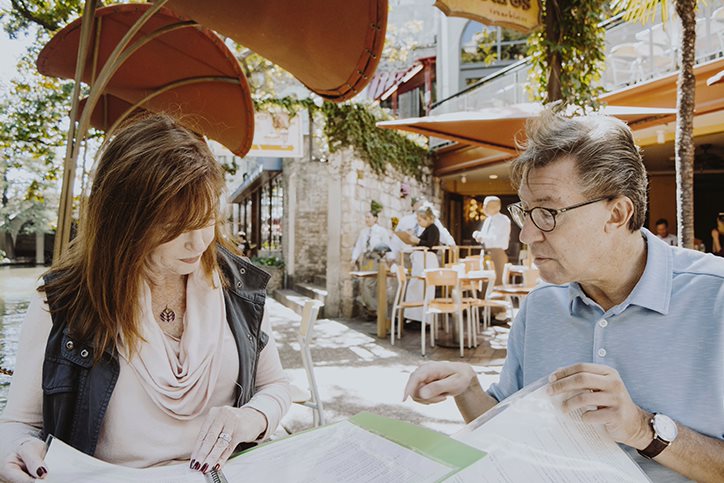 Two people preplanning outside at a table