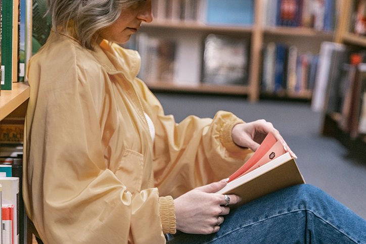woman reading book in a library