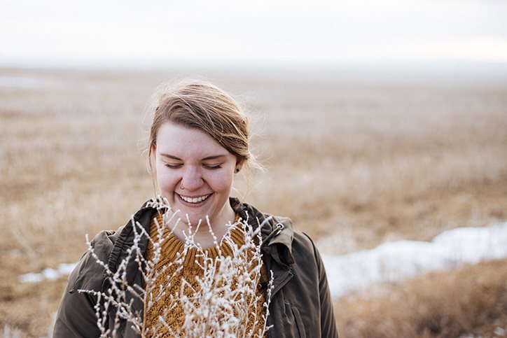 Millennial woman in a winter field