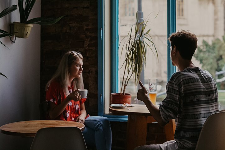 Two people talking in a coffee shop