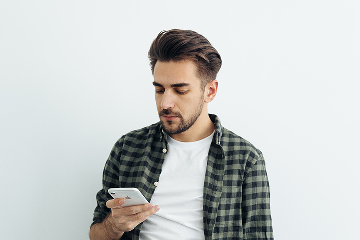 Man looking at phone in hand