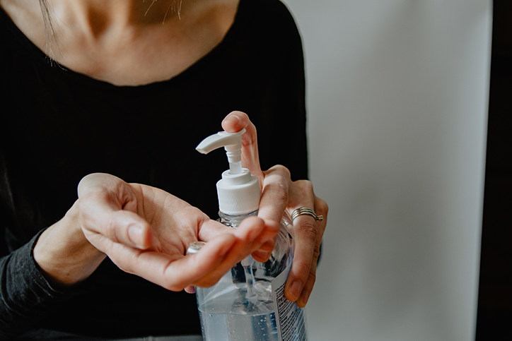 Woman about to use hand sanitizer