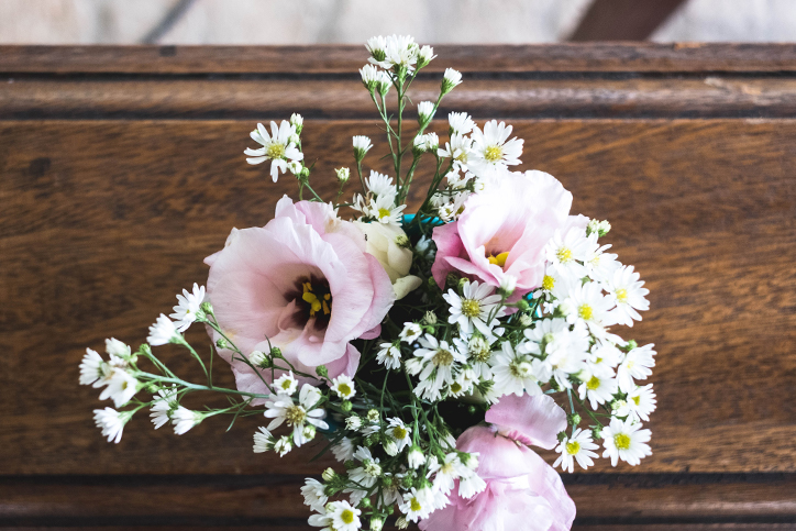 bouquet of flowers on a wooden structure