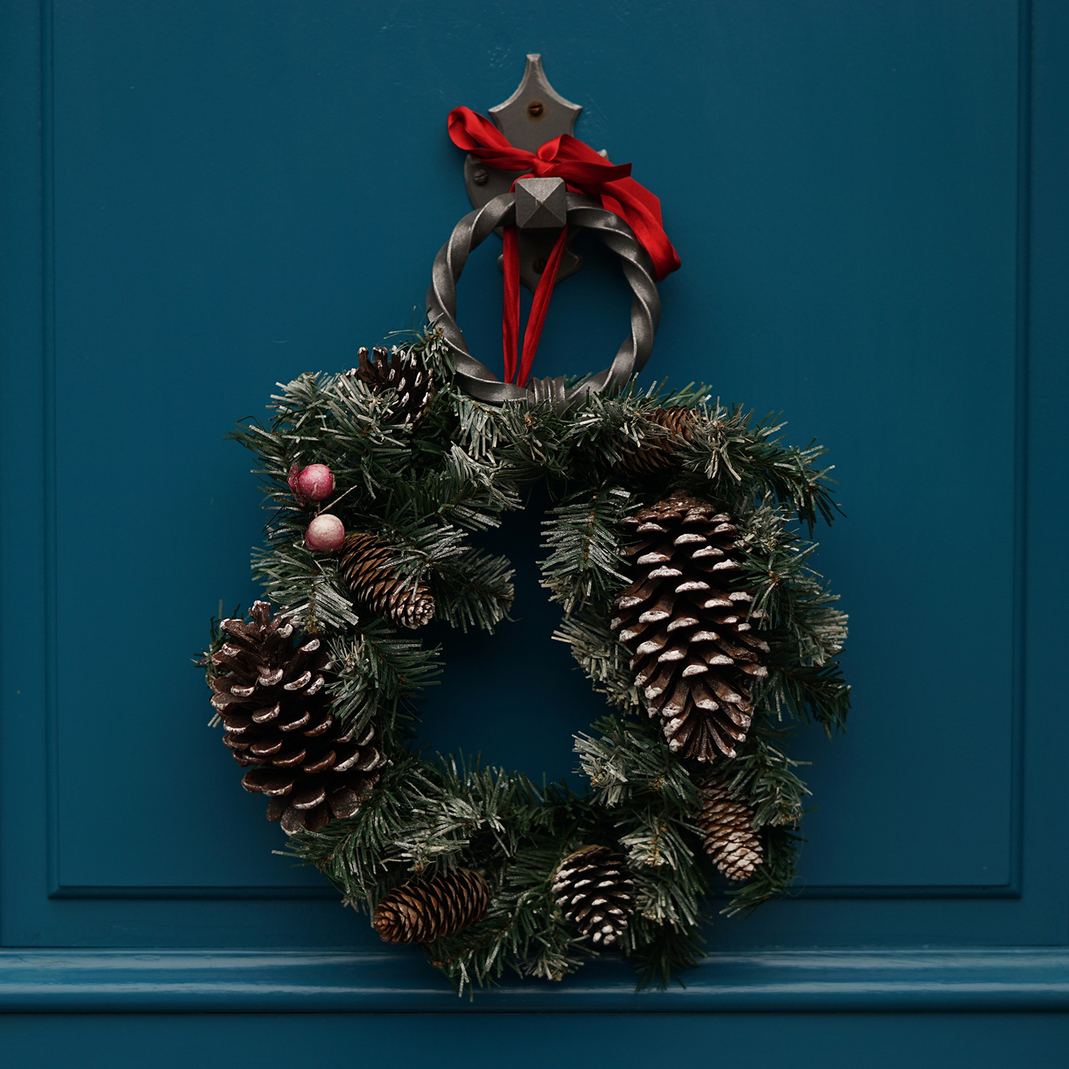A holiday wreath on a blue door
